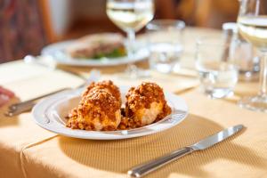 two pieces of food on a plate on a table at Beohotel in San Lorenzo in Banale