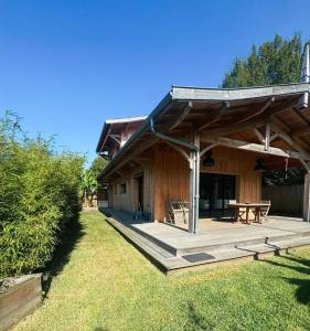 a wooden pavilion with a picnic table in front of it at Villa Andernos les Bains in Andernos-les-Bains