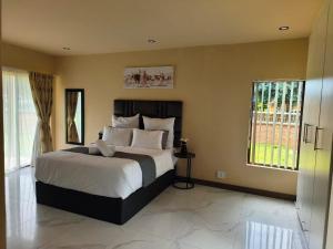 a bedroom with a large bed and a window at Masithandane lodge in Richards Bay +44 photos