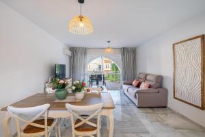 a living room with a table and a couch at Apartamento isabel golf center in Almería