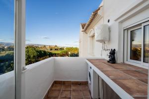 a kitchen with a balcony with a view at Apartamento isabel golf center in Almería