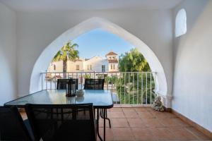 a table and chairs on a balcony with a view at Apartamento isabel golf center in Almería