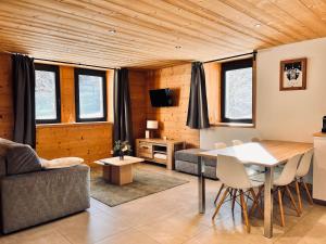 a living room with a table and chairs at Appartement Chalet Louison in Les Gets +21 photos