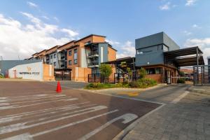 an empty street in front of a building at The Waterfallcity Charm next to Mall of Africa in Midrand