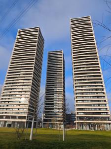 three tall buildings in a city with a park at Sun Tower in Zurich