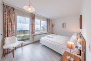 a bedroom with a bed and a window at Appartementhaus-Quadern in Valens