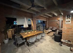 a dining room with a wooden table and chairs at Glamping in Pueblo Magico Alamos Sonora in Álamos
