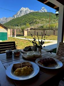 a wooden table with plates of breakfast food on it at Lagusheda in Nashtkoli