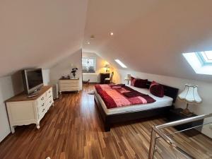 a bedroom with a bed and a television in it at Vintage Traum in Hückelhoven