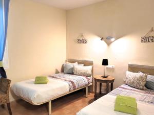 two beds in a room with green pillows at Apartment En Capillo in Manacor +14 photos