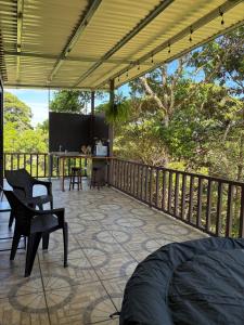 a patio with a table and chairs on a deck at Cabaña BosKaL in Quesada