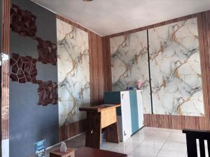 a kitchen with a wall decorated with marble at Sony massage in Gili Trawangan