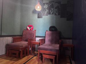 a room with two chairs and a table with a red object at Sony massage in Gili Trawangan +2 photos