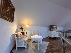 a living room with a table and chairs and a tv at Vintage Traum in Hückelhoven