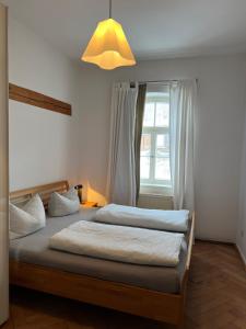 a bedroom with two beds and a window at Haus mit Geschichte in Mähring in Mähring