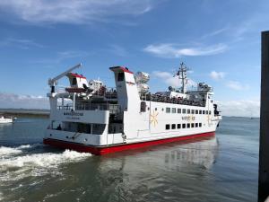 a ferry boat floating in the water at Wilder Klaus in Wangerooge