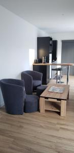 a living room with two chairs and a coffee table at Campaville in Maurepas