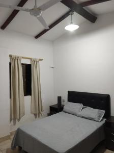 a bedroom with a bed and a ceiling fan at Las Toribias II in El Rincón