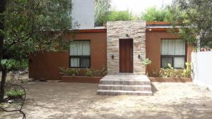 a brick house with a door in a yard at Las Toribias II in El Rincón