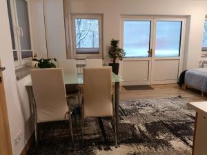 a dining room with a table and chairs and a bed at Apartmán Eliška v Karolince in Karolinka