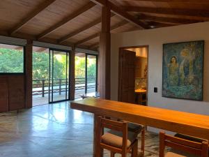 a dining room with a table and a painting on the wall at Frondavista San Pancho in San Francisco