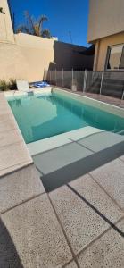 a swimming pool in front of a house at Habitación en suite in San Rafael