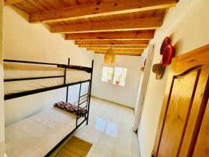 a bedroom with two bunk beds in a room at Waves Surf House in Taghazout