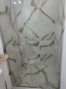 a shower with a glass door in a bathroom at Vila Boutique Cozy in Nucşoara +50 photos