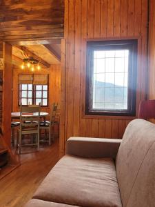 a dining room with a table and a window at Vila Boutique Cozy in Nucşoara