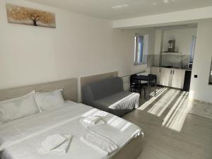 a bedroom with a bed and a couch and a chair at Max Night Dreams in Bucharest +39 photos