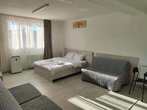 a hotel room with a bed and a chair at Max Night Dreams in Bucharest