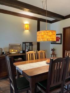 a dining room with a wooden table and chairs at Canto do Cururuá - IlhaBela in Ilhabela