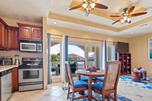 a kitchen with a table and chairs and a dining room at Grand Caribe Belize in San Pedro