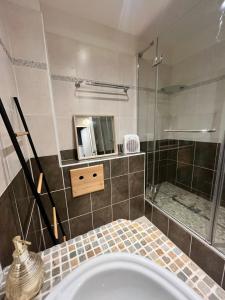 a bathroom with a shower and a sink and a tub at Praloup 1600 t3 sur piste 4p in Uvernet +21 photos