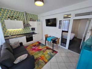 a living room with a couch and a kitchen with a table at Hotel Bellevue in Kranj