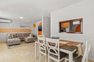 a dining room and living room with a table and chairs at Comfortable Home for 6 Near Airport & Beaches in Carolina