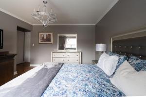 a bedroom with a large bed and a chandelier at Spacious Bright Home In Woodbridge in Vaughan
