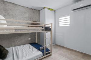 a bedroom with two bunk beds in a room at Comfortable Home for 6 Near Airport & Beaches in Carolina +15 photos