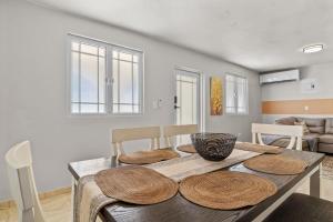 a dining room with a table with wooden plates on it at Comfortable Home for 6 Near Airport & Beaches in Carolina