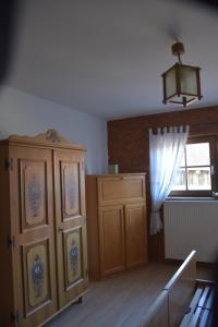 a kitchen with a wooden cabinet and a window at Pension Aigner in Waldkirchen