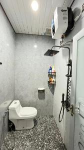 a bathroom with a toilet and a camera in it at Jati Homestay Batam Center in Batam Center +3 photos