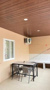 a dining room with a table and two chairs at Jati Homestay Batam Center in Batam Center