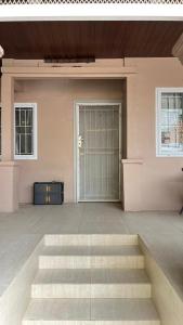 a large room with stairs in front of a door at Jati Homestay Batam Center in Batam Center