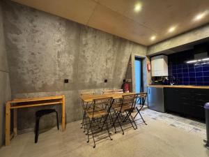 a kitchen with a table and chairs in a room at Sardines Rooms & Apartment in Póvoa de Varzim
