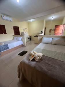 a bedroom with two beds with a stuffed animal on the bed at Pousada Maracajaú in Maracajaú +64 photos