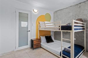 a bedroom with two bunk beds and a mirror at Comfortable Home for 6 Near Airport & Beaches in Carolina