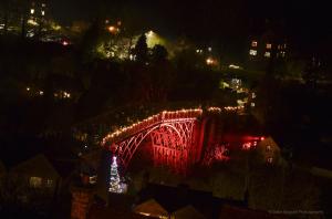 a lit up bridge with christmas lights on it at night at Ironbridge Tiny Hideaway in Ironbridge