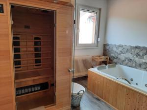 a bathroom with a bath tub and a window at Apartmán Eliška v Karolince in Karolinka +5 photos