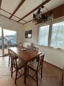 a dining room with a wooden table and chairs at Casa Gioia in Besano