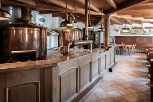 a large kitchen with a counter with many wine barrels at Stanglbräu in Hausen